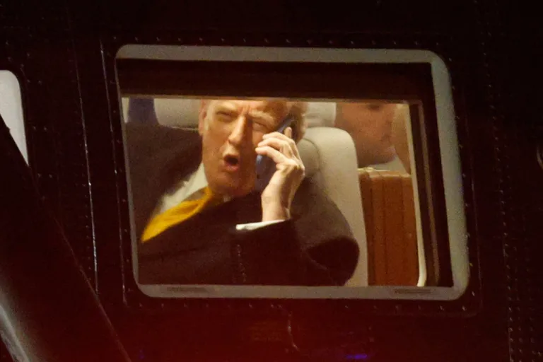 President Donald Trump talks on his phone in Marine One upon his arrival at Joint Base Andrews, Md., Friday, Nov. 7, 2025, en route to his Mar-a-Lago estate in Palm Beach, Fla.