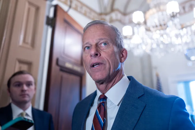 Senate Majority Leader John Thune, R-S.D., speaks to reporters as he arrives at his office following a weekend vote to move forward with a stopgap funding bill to reopen the government through Jan. 30, at the Capitol in Washington