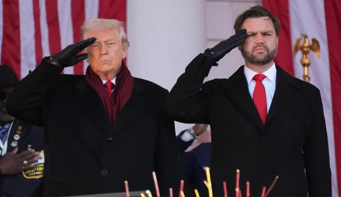 President Donald Trump, left, and Vice President JD Vance, right, salute before speaking during an event to mark Veterans Day