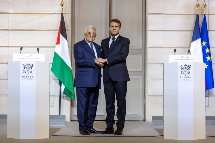 French President Emmanuel Macron shakes hands with Palestinian President Mahmoud Abbas.