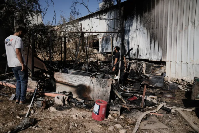 Palestinians survey damage in an industrial zone following an attack by Israeli settlers the day before in the West Bank village of Beit Lid.