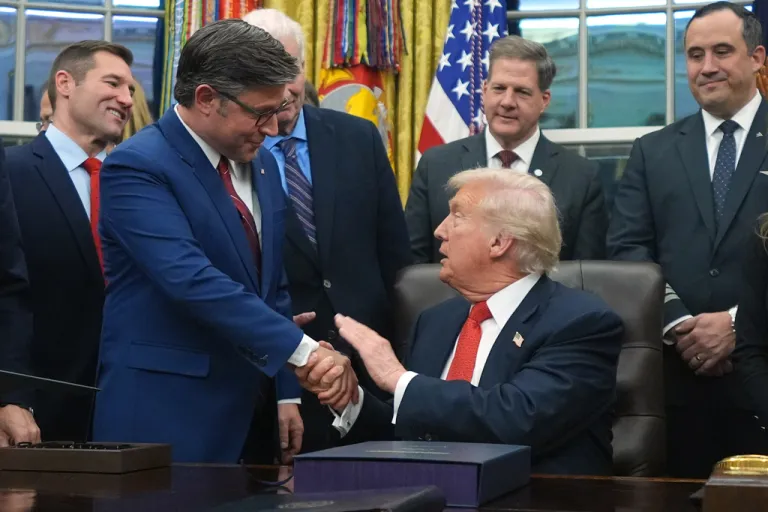 Trump shakes hands with House Speaker Mike Johnson.