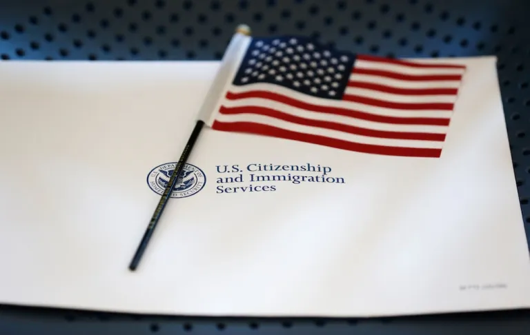 FILE - An information packet and an American flag are placed on a chair at the U.S. Citizenship and Immigration Services Miami Field Office on Aug. 17, 2018, in Miami. (AP Photo/Wilfredo Lee, File)