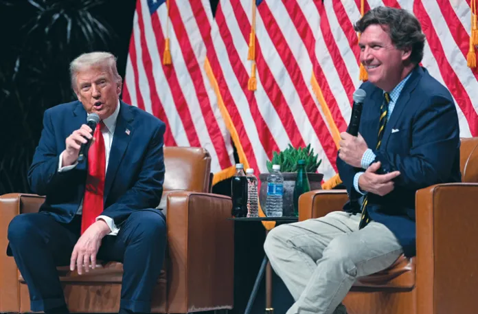 President Donald Trump speaks with Tucker Carlson during a Tucker Carlson Live Tour show at Desert Diamond Arena, Thursday, Oct. 31, 2024, in Glendale, Arizona.  (Julia Demaree Nikhinson/AP)
