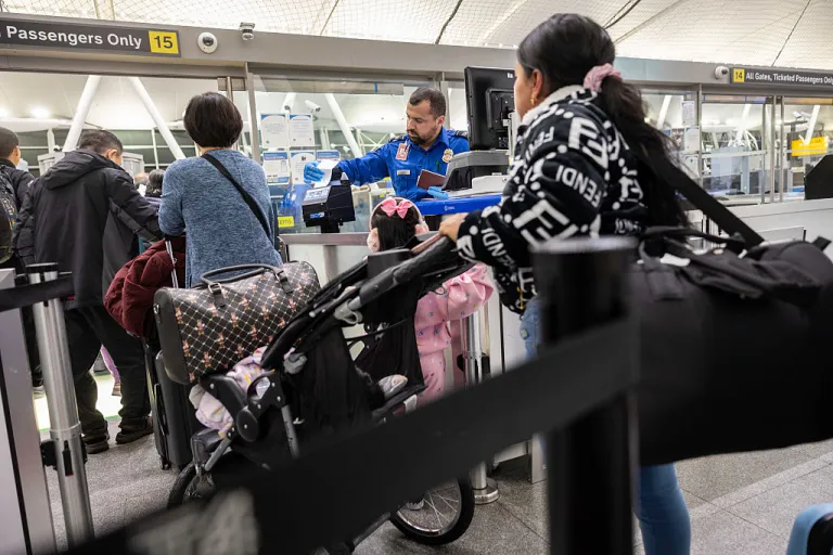 Ecuadorian immigrant Andrea, 28, prepares to pass through a TSA checkpoint before departing with her children for Ecuador at JFK International Airport on October 26, 2025 in New York, New York. Andrea, along with her cousin Jennyfer, 22, decided to 