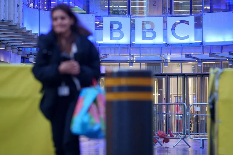 Following the resignations of BBC Director General Tim Davie and CEO of news Deborah Turness and US President Donald Trump's threat of a lawsuit due to the editing of a BBC Panorama film about the US insurrection on the US Capitol, a staff member leaves Broadcasting House, on 10th November 2025, in London, England. (Photo by Richard Baker / In Pictures via Getty Images)