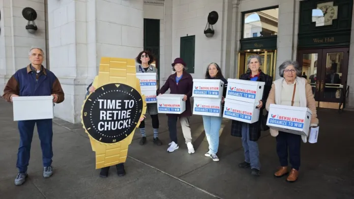 Activists with the progressive organization Our Revolution gather before delivering a "retirement gift" and digital petition signatures to Sen. Chuck Schumer (D-NY) calling on him to resign as leader of Senate Democrats