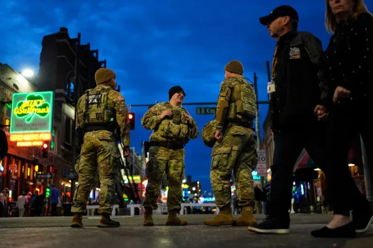Members of the National Guard stand watch at the intersection of B.B. King Blvd. and Beale Street, Friday, Oct. 24, 2025, in Memphis, Tenn. (AP Photo/George Walker IV)