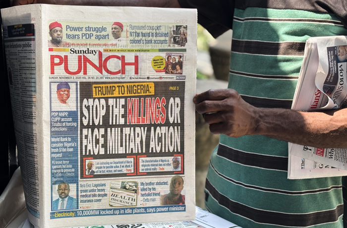 A vendor sells local newspapers with headlines referring to President Donald Trump’s comments about Nigeria on the street of Lagos, Nigeria. (Sunday Alamba/AP)