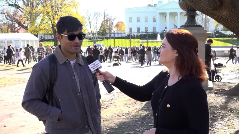 Two people standing in front of White House