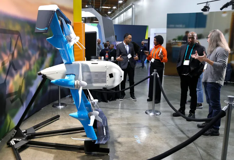 Guests at Amazon's Delivering the Future explore the MK30, Amazon's newest Prime Air drone that can fly in light rain and deliver packages up to five pounds in under an hour in Sumner, WA.