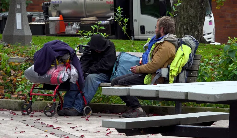two men sitting on a bench