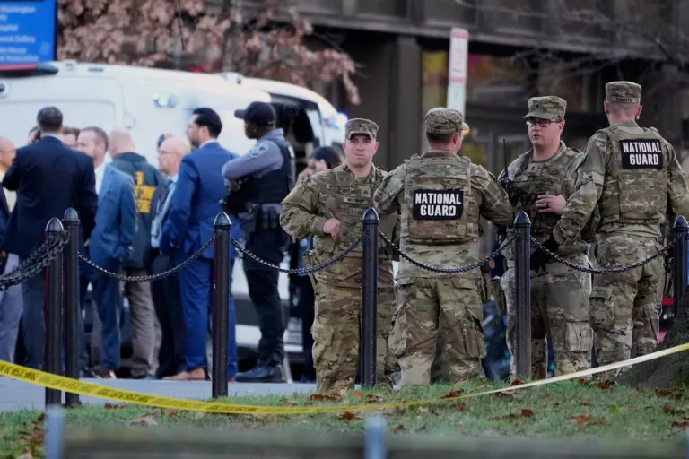 Emergency personnel gather in a cordoned off area where National Guard soldiers were shot near the White House.