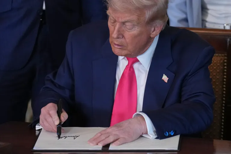 President Donald Trump signs an executive order.