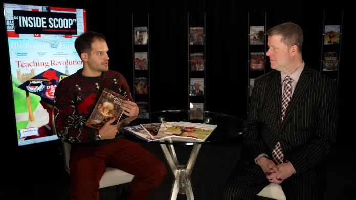 two men sitting at desk.