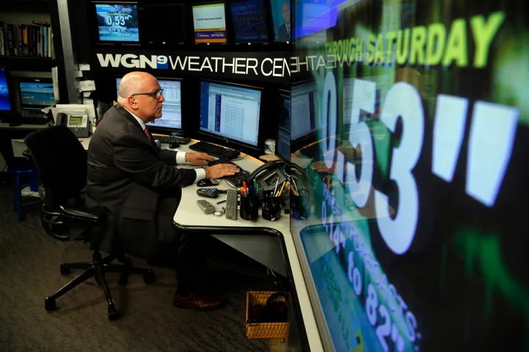 WGN-TV Midday News meteorologist Tom Skilling prepares in his work space at the WGN television studios in Chicago, July 1, 2013. Skilling, long time WGN-TV meteorologist and a well-known local personality, will retire next year after 45 years at the station. (Jose M. Osorio/Chicago Tribune via AP)