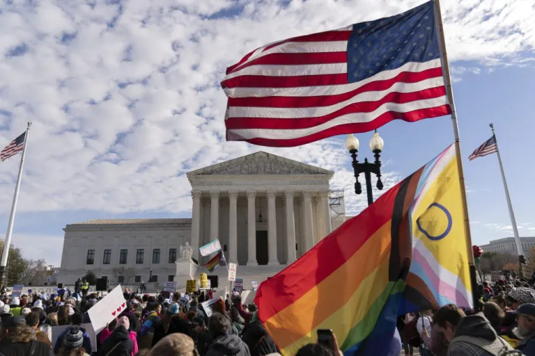 Transgender rights supporters rally outside of the Supreme Court.