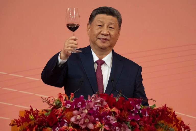 Xi Jinping raises a wine glass at a celebration in Beijing