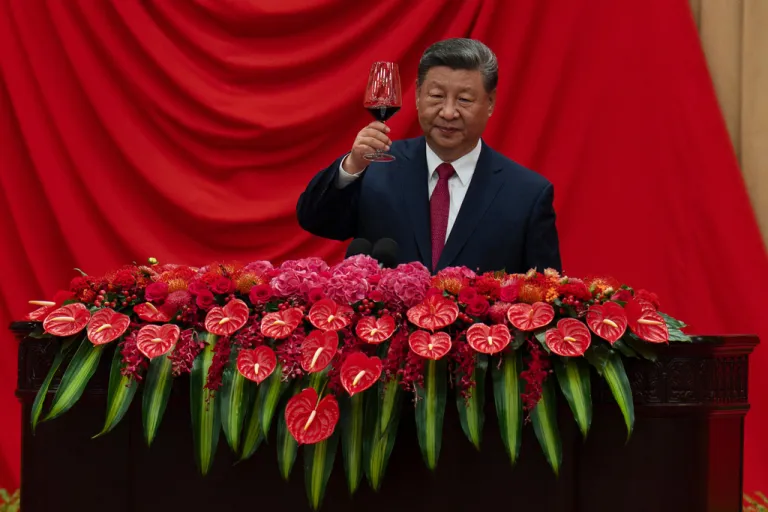 Chinese President Xi Jinping raises his glass to toasts after speaking at the National Day Reception at the Great Hall of the People on the eve of the 76th anniversary of the founding of the People's Republic of China in Beijing, Tuesday, Sept. 30, 2025. (AP Photo/Ng Han Guan)