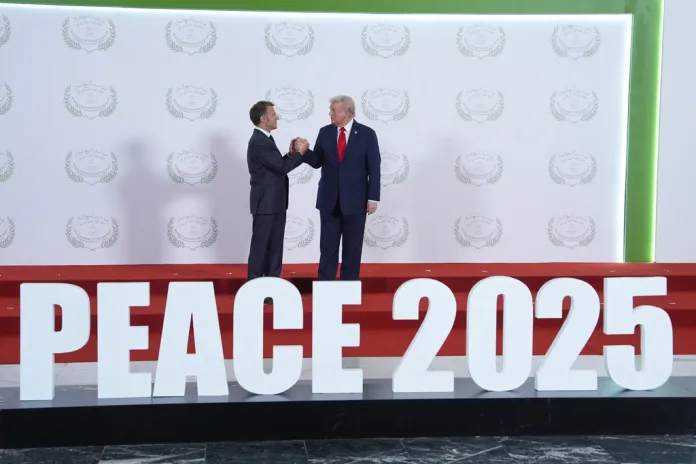 President Donald Trump greets France's President Emmanuel Macron during a summit Monday, Oct. 13, 2025, in Sharm El Sheikh, Egypt.