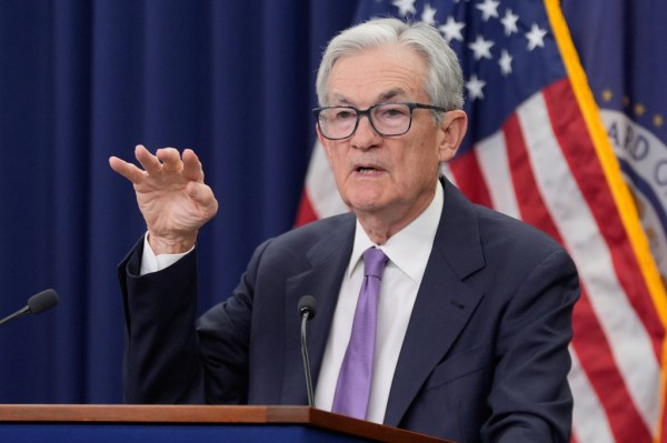 Fed cuts interest rate target, but future uncertain as Trump pushes looser money