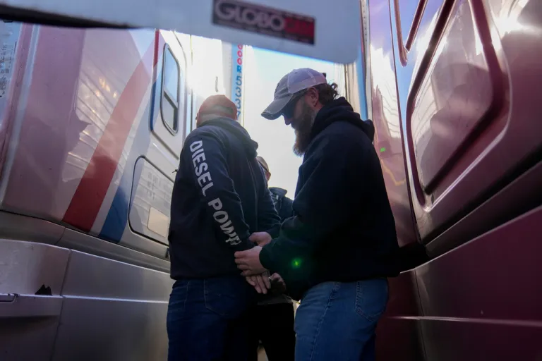 U.S. Border Patrol agents detain a truck driver during an immigration enforcement operation at a truck stop Monday, Nov. 3, 2025, in Hampshire, Ill. (AP Photo/Erin Hooley)