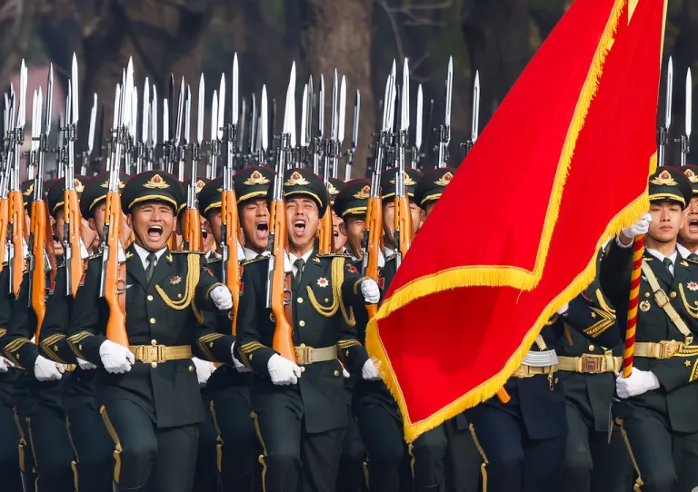 People's Liberation Army honor guard marches past the Great Hall of the People