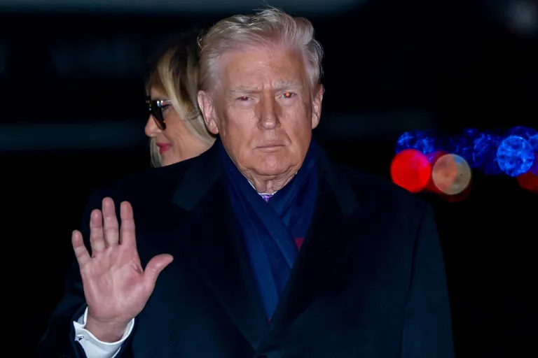 President Donald Trump waves as he and first lady Melania Trump arrive on Air Force One, Sunday, Nov. 30.