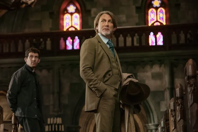 This image released by Netflix shows Josh O'Connor, left, and Daniel Craig in a scene from 