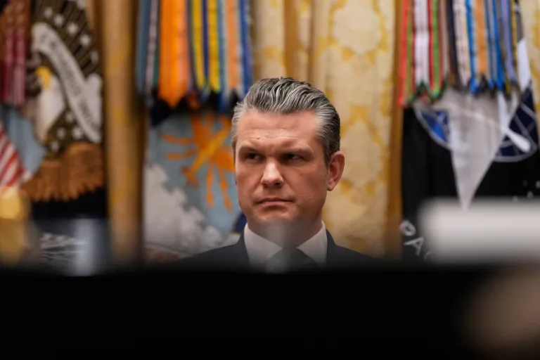 Defense Secretary Pete Hegseth listens as President Donald Trump speaks