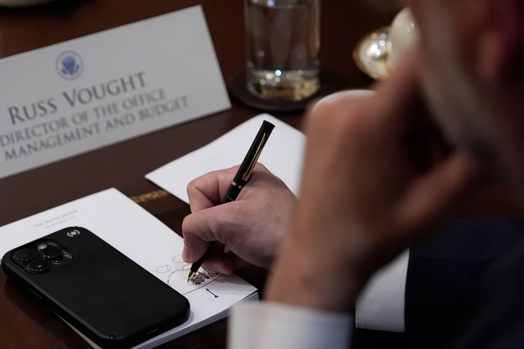 Russell Vought, head of the Office of Management and Budget, doodles on a notepad during a Cabinet meeting at the White House.