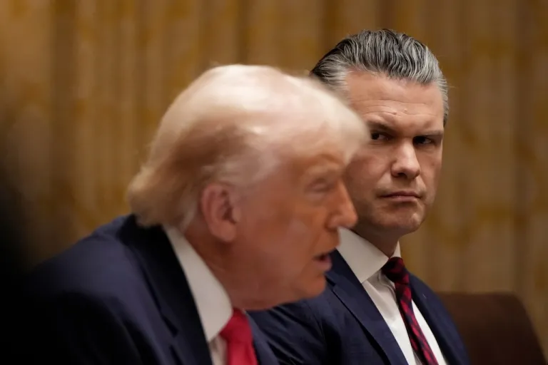 Defense Secretary Pete Hegseth watches as President Donald Trump speaks during a Cabinet meeting.