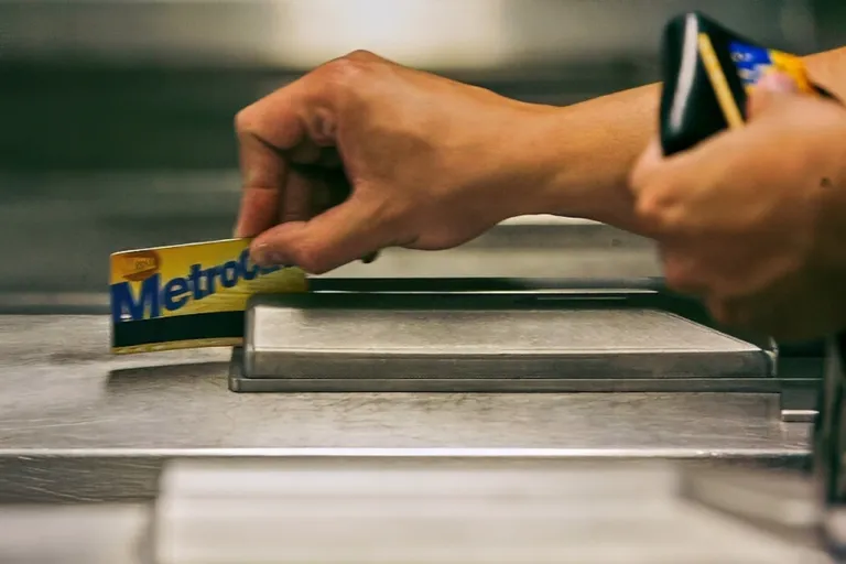 A subway rider swipes his MetroCard in a turnstile