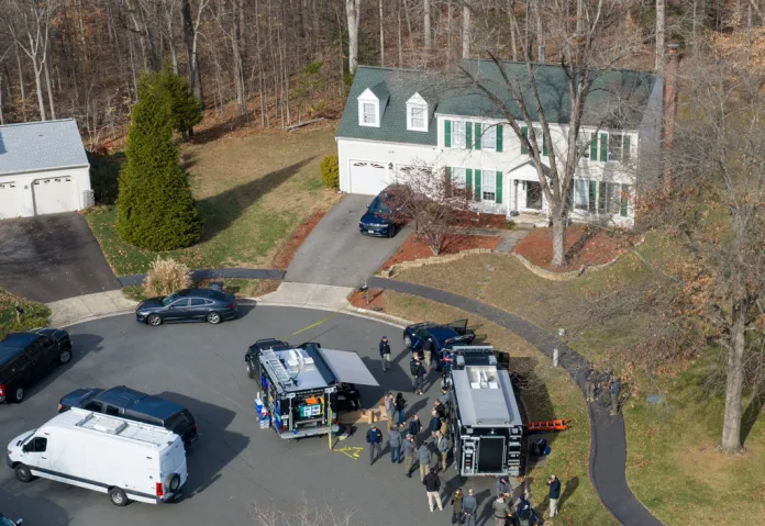 Prince William County Police block the street near a house where the FBI made an arrest.