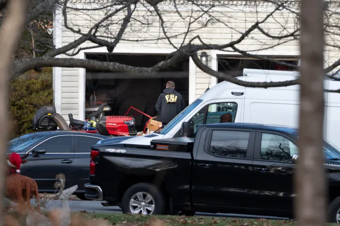 FBI agents outside the home of Brian Cole, the defendant in the Jan. 6 pipe bomber case.
