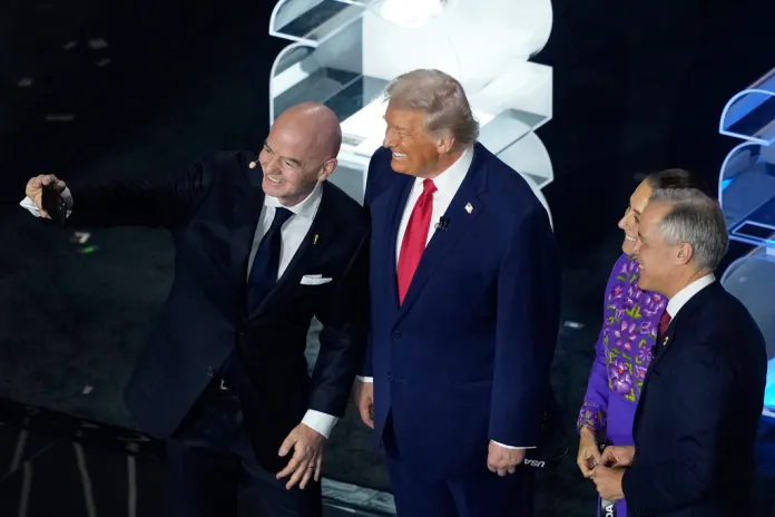 FIFA President Gianni Infantino takes a selfie with President Donald Trump, Mexican President Claudia Sheinbaum, and Canadian Prime Minister Mark Carney onstage.