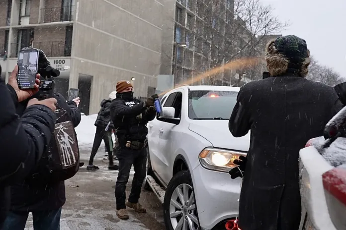 Activists confronted a group of Immigration and Customs Enforcement officers in the largely Somali neighborhood of Cedar-Riverside in Minneapolis, Tuesday, Dec. 9, 2025. (AP Photo/Mark Vancleave)