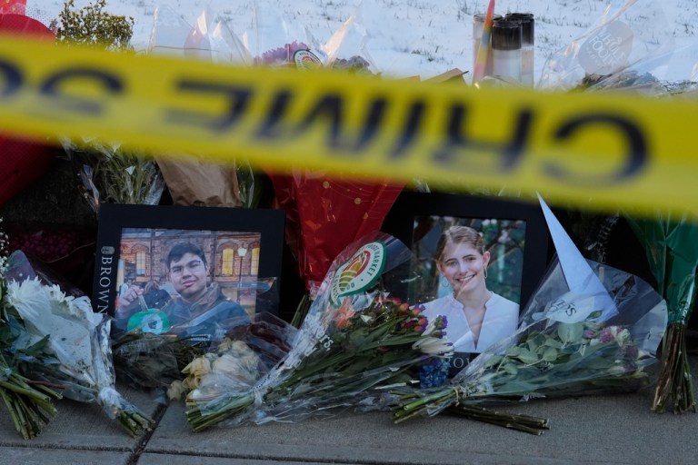 Photos of Brown University shooting victims Mukhammad Aziz Umurzokov, left, and Ella Cook, are seen amongst flowers at a makeshift memorial