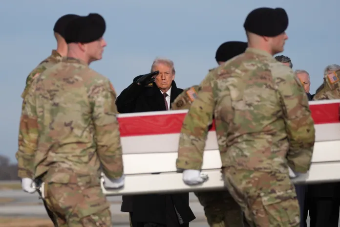 President Donald Trump salutes as an Army carry team moves the flag-draped transfer case.