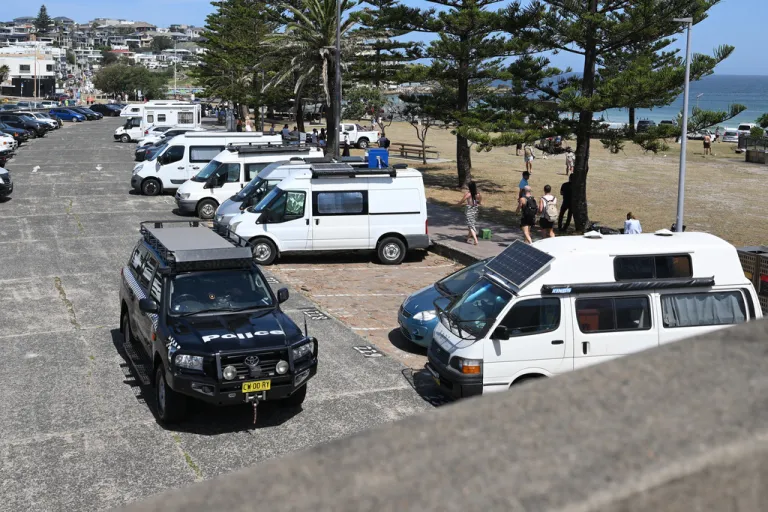 Police patrol the scene of last Sunday's shooting at Bondi Beach.