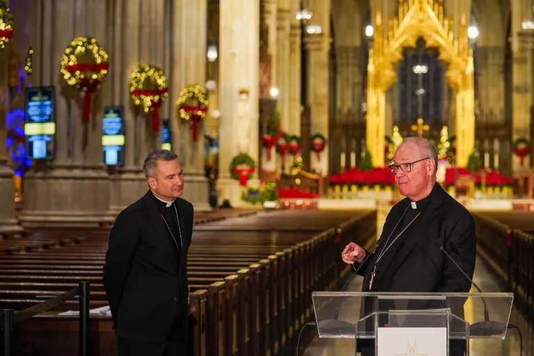 New York Archbishop Timothy Dolan greets Bishop Ronald Hicks during a news conference.