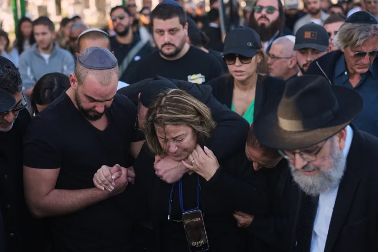 Annie, center, mourns over the body of her son Dan Elkayam, a young French Jewish man who was killed in the mass shooting that targeted a Hanukkah celebration on Sydney's Bondi Beach in Australia, during his funeral in Ashdod, Israel, Thursday, Dec. 25, 2025.