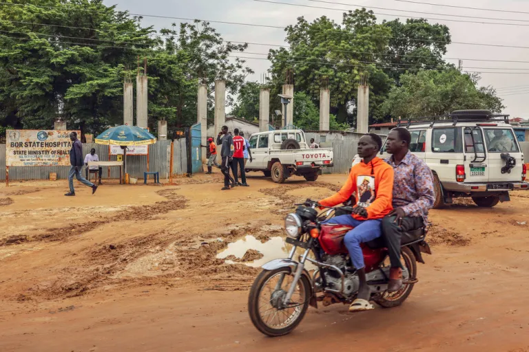 FILE - Motorists pass outside Bor State Hospital in Bor, South Sudan, Monday, Aug. 18, 2025. (AP Photo/Caitlin Kelly, File)