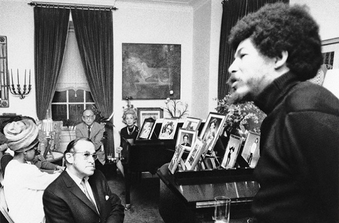 In a scene immortalized by writer Tom Wolfe as a case of ‘radical chic,’ a bearded Donald Lee Cox, field marshal of the Black Panther Party, right, speaks at cocktail party in the Park Avenue home of composer Leonard Bernstein in New York City in January 1970. Bernstein’s wife is seated at the rear, and listening in the foreground is attorney Leon Quat. (Associated Press)