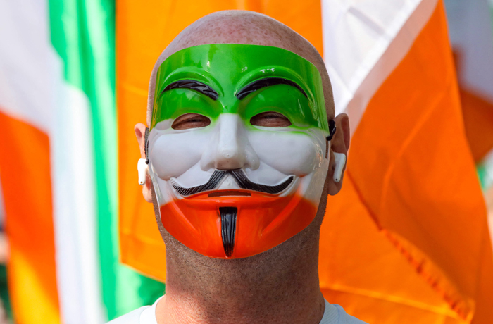 A masked anti-Immigration protester at a march near the Irish Parliament, Sept. 19, 2024. (Paul Faith/AFP/Getty )