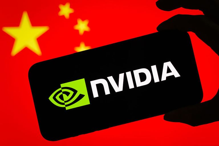 CHONGQING, CHINA - JULY 17: In this photo illustration, a smartphone displaying the logo of Nvidia Corporation (NASDAQ: NVDA), a leading American semiconductor and artificial intelligence company, is held in front of a screen showing the national flag of China on July 17, 2025 in Chongqing, China. (Photo illustration by Cheng Xin/Getty Images)