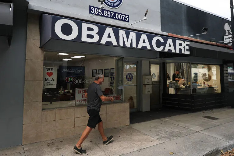 An Obamacare sign is displayed outside an insurance agency on November 12, 2025 in Miami, Florida. House Democrats are said to be looking at steps to force a vote on extending the expiring Affordable Care Act tax credits after Republicans did not address the issue as part of a deal to reopen the federal government. The House is expected to vote today on ending the record-long government shutdown. (Photo by Joe Raedle/Getty Images)