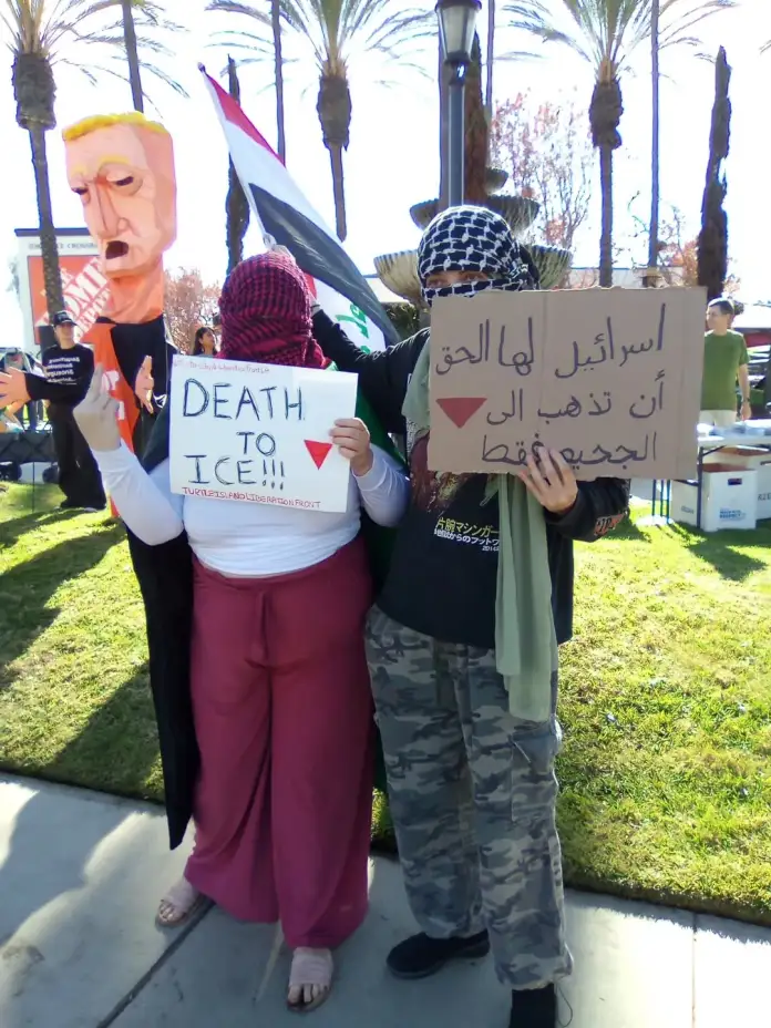 Turtle Island Liberation Front activists wear keffiyehs and hold signs saying "Death to ICE."