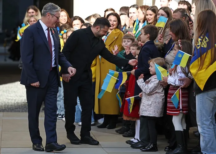 British Prime Minister Keir Starmer and Ukrainian President Volodymyr Zelenskyy are greeted by Ukrainian school children.