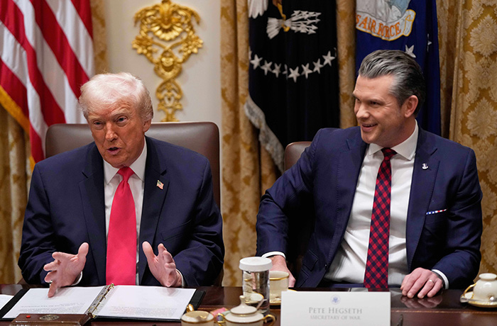 President Donald Trump speaks during a Cabinet meeting at the White House on Dec. 2, as Defense Secretary Pete Hegseth looks on. (Julia Demaree Nikhinson/AP)